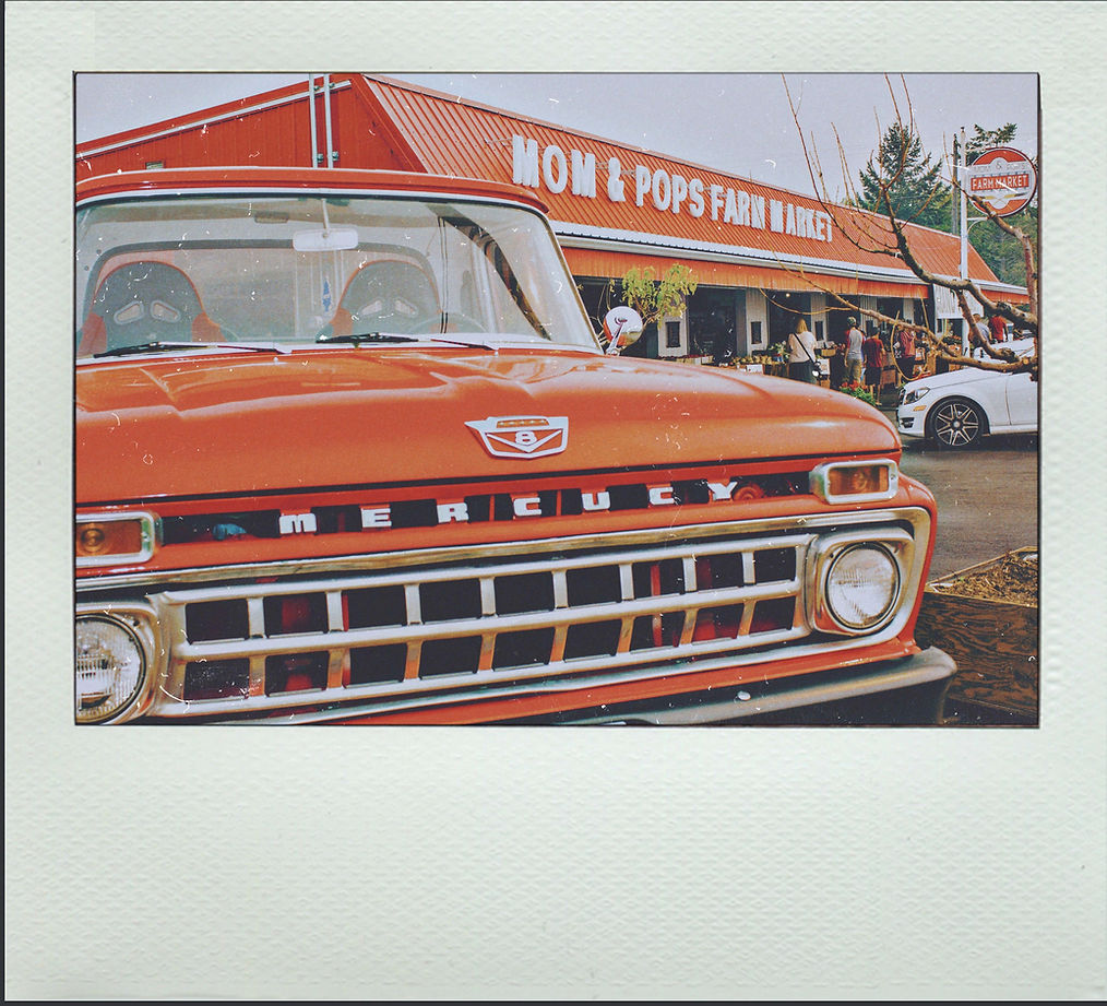 The iconic red Mercury truck in front of Mom and Pop's Farm Market.
